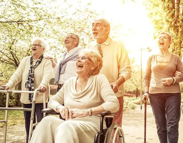 A group of people standing around laughing.