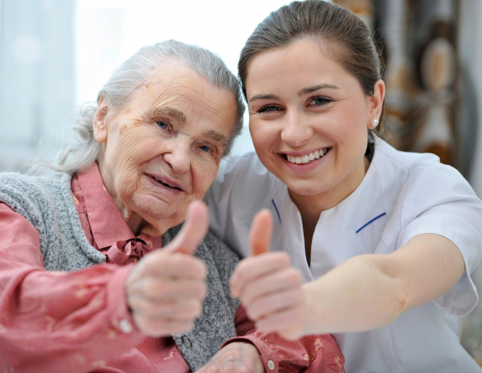 A woman and an old lady giving thumbs up.